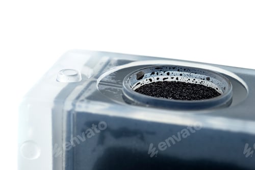Preview: Macro photo of a black ink cartridge for a color printer, isolated on white background.