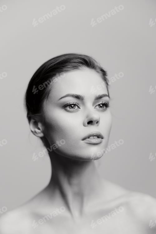 Preview: Young woman with a graceful pose, showcasing elegance and poise against a soft gray background
