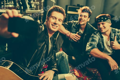 Preview: selective focus of cheerful man taking selfie with happy friends