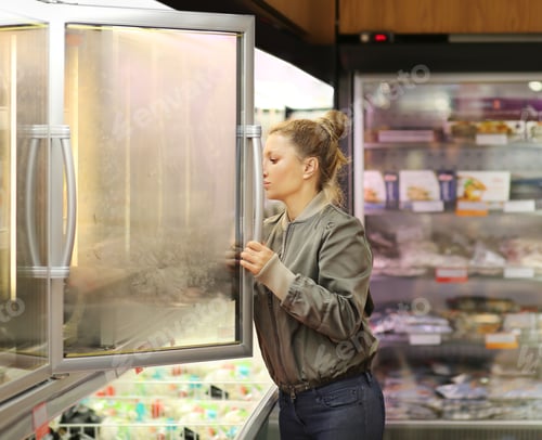 Preview: Woman Choosing Frozen Food From A Supermarket Freezer