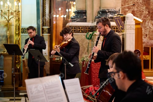 Preview: Musicians performing at a concert in a church during the evening service