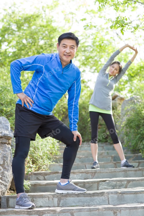 Preview: Happy mature couple exercising in park