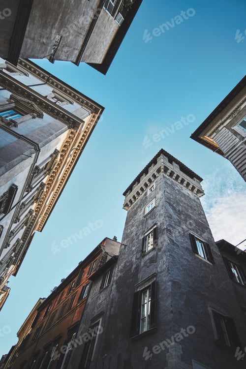 Preview: Vertical low-angle shot of old buildings against the background of blue sky. Rome, Italy.
