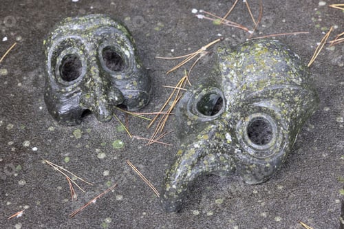 Preview: two masks on a grave stone