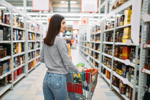 Preview: Woman with cart in alcohol drinks department