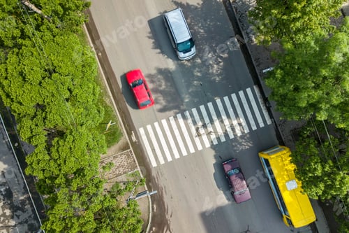 Preview: Top down aerial view of busy street with moving cars traffic and zebra road pedestrian crosswalk