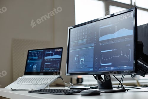 Preview: Computers on Desk with Data Screens