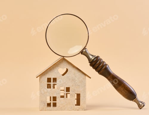 Preview: Wooden house and a magnifying glass, representing the concept of real estate purchase, rental growth