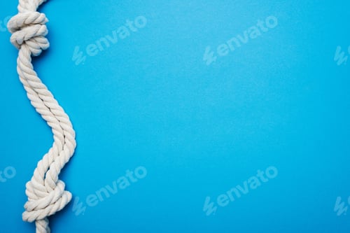 Preview: white, twisted, nautical ropes with sea knot isolated on blue