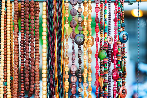 Preview: Colorful necklaces at outdoor small souvenir shop in Italy. Decorative colorful crystal chaplets
