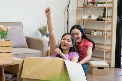 Preview: Playful joy A lesbian couple celebrating in a moving box