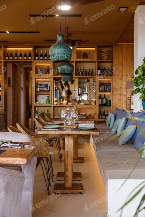 Preview: Decorated tables in a restaurant with a modern interior design, wooden shelves and tables