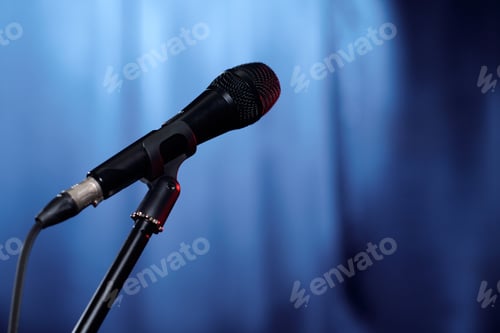 Preview: Microphone on stage with blue curtains