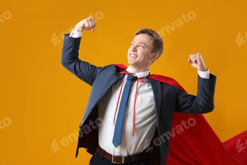 Preview: Businessman wearing superhero cape on yellow background