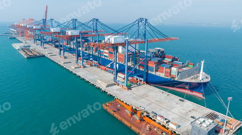 Preview: crane loading cargo container from truck to container ship in the international terminal