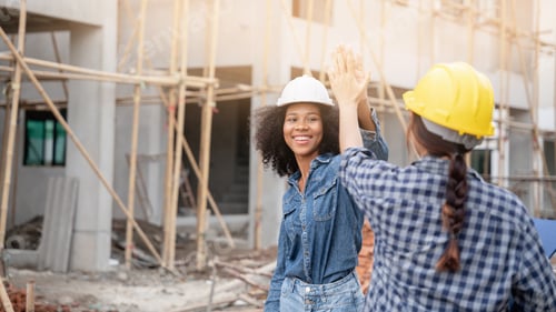 Preview: The engineer manager and forewoman construction workers shake hands on the construction site