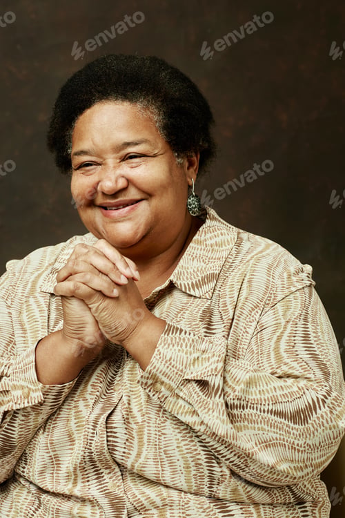 Preview: Portrait of Smiling Black Woman Folding Hands on Brown Background