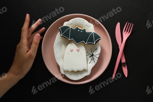Preview: Pink cutlery with cookies on a black background