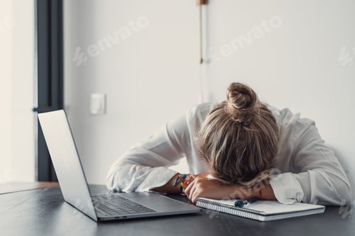 Preview: Exhausted young Caucasian female employee sleep desk at office overwork preparing report.