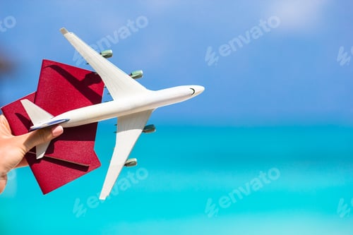 Preview: Closeup of passports and white airplane background the sea