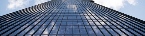 Preview: Panorama of tall glass building against blue sky