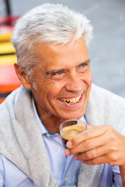 Preview: Close up smiling handsome man holding cup of coffee