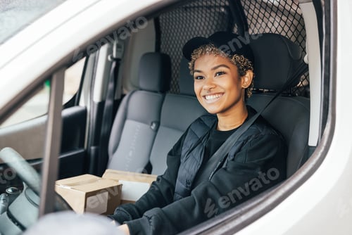 Preview: Portrait of a smiling woman working for delivery company sitting in a car looking away