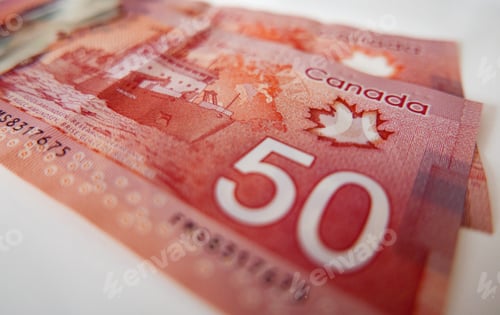 Preview: Closeup shot of Canadian money on a white surface