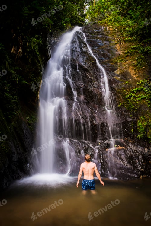Preview: Tourist swimming under Cucharillos Waterfall in the Mashpi Cloud Forest area of the Choco Rainforest