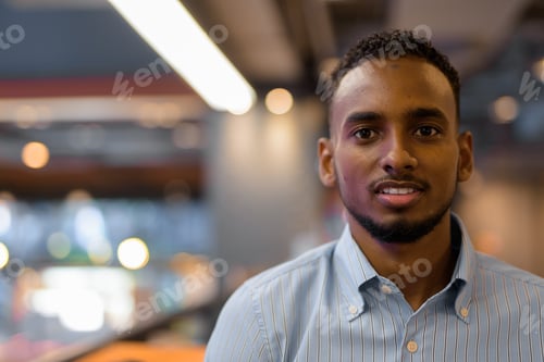 Preview: Portrait of handsome black African businessman inside shopping mall
