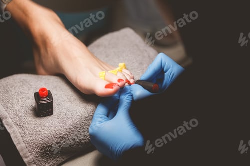 Preview: Master does pedicure for client. Pedicure process. Girl draws toenails