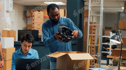 Preview: Entrepreneurs team looking at goods and packaging