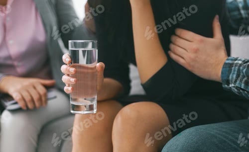 Preview: Woman Holding a Glass of Water During a Therapy Session