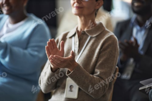 Preview: Hands of mature businesswoman applauding to speaker at conference