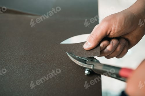 Preview: close up of a Worker hands use scissors to cut the metal sheet