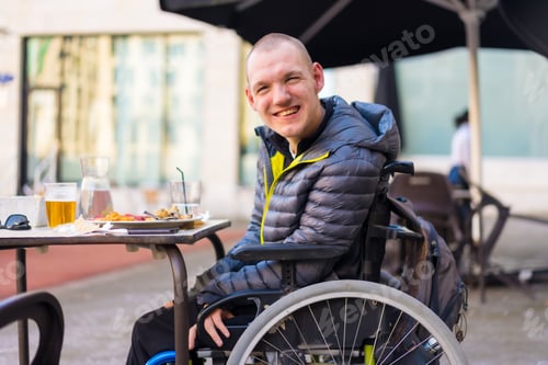 Preview: Portrait of a disabled person in a wheelchair in a restaurant, normality of disabled people