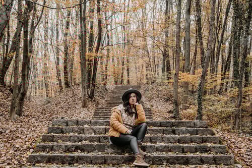 Preview: Shot of a beautiful woman sitting in an autumn park