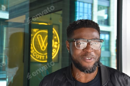 Preview: urban portrait of a black man with beard and glasses