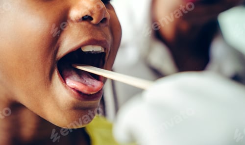 Preview: Pediatrician examining little girl's throat with tongue depressor
