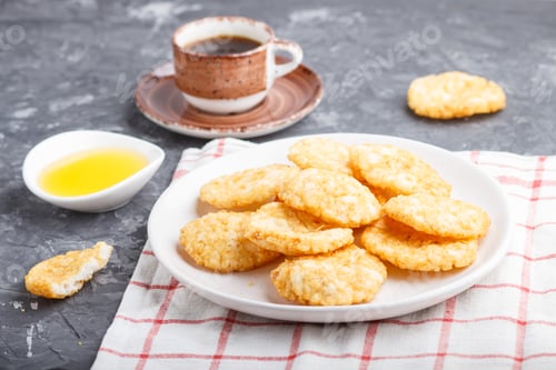 Preview: Traditional japanese rice chips cookies with honey and soy sauce on a white ceramic plate