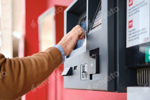 Preview: close up shot of man buying ticket on automatic machine. unrecognizable person
