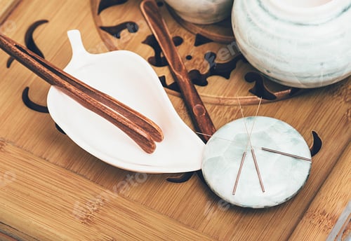 Preview: Acupuncture needles lie on a stone for massage close-up. Alternative medicine composition