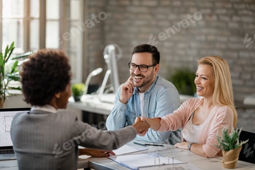 Preview: Happy couple greeting with financial advisor in the office.