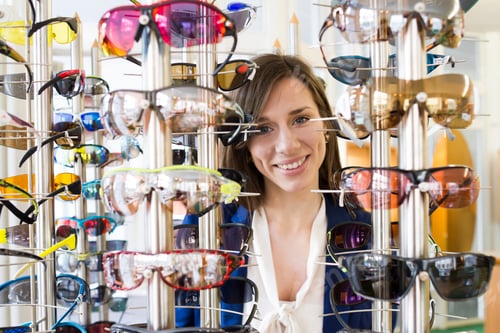Preview: View through eyeglasses display of woman looking at camera smiling