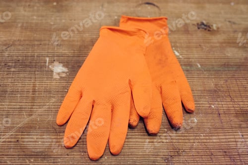 Preview: Pair of industrial orange gloves on a wooden surface