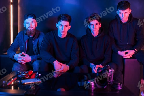 Preview: Group of people is together in the studio with futuristic neon lighting