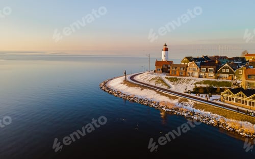 Preview: panoramic view of the Lighthouse of Urk during winter with snow in the Netherlands