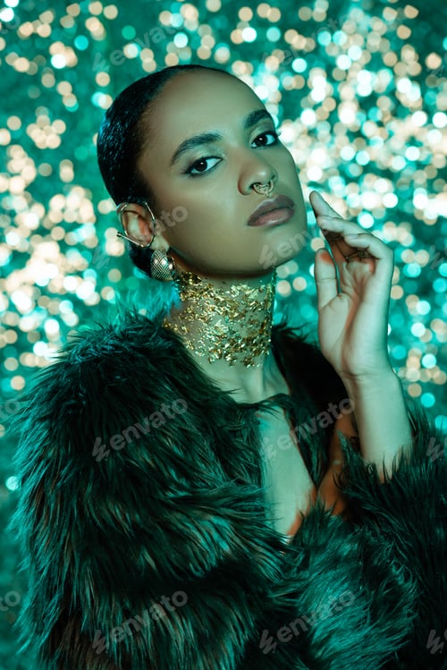 Preview: brunette african american woman in trendy faux fur jacket and gold on neck looking at camera