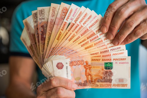 Preview: Russian rubles in the hand of a fan.male hand holding many of the Russian banknotes.The transfer of