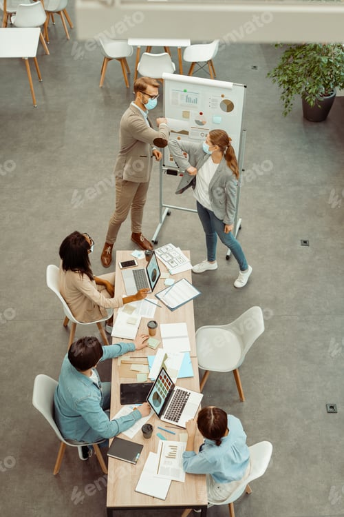 Preview: Two colleagues standing in the meeting room in the office